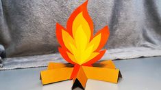 an origami fire is sitting on top of a table