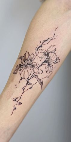 a woman's arm with flowers on it and the word love written in black ink