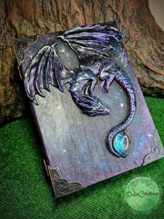 a purple and blue dragon on a wooden plaque