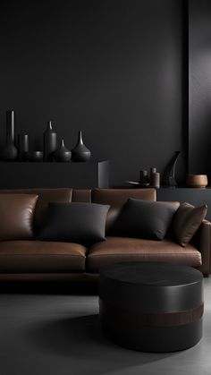 a living room with black walls and leather furniture