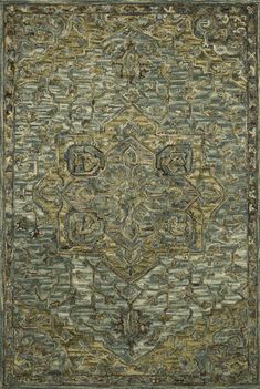 a green rug with an ornate design on the bottom and sides, in various colors