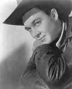 a black and white photo of a man wearing a cowboy hat