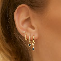 Add a touch of sparkle to your golden stack with our Rhodes Earrings. Cool and on-trend, the blue-coloured stone hangs from a perfectly adorned hoop to make a classic everyday earring that will glam up your stack!18k Gold plated (1 micron plating)Sterling Silver BaseBlue Zircon StoneE-coating for a premium finishLead & Nickel Free CARE GUIDECARING FOR YOUR AOE JEWELSAt Arms Of Eve, we take great pride in the quality of all our jewels. All of our pieces are suitable for daily wear. Our jewels are Dainty Earrings Dangle, Gold Jrwelry With Navy Dress, Everyday Ear Rings, Dath Piercing Earrings, Aimple Earrings, Casual Jewelry Earrings, Navy Earrings, Earrings Cool, Double Earrings