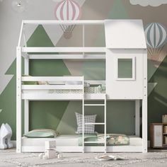 a white bunk bed sitting next to a green wall with hot air balloons on it