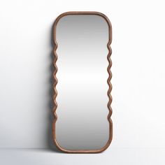 a wooden mirror hanging on the wall