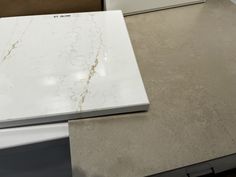 a white counter top sitting on top of a kitchen counter next to a freezer