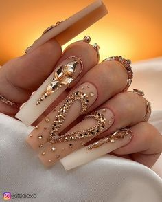 Long coffin nude matte nails with rose gold rhinestones bling nails long nail inspo nail ideas designs  #Nails2Inspire #nailspromote #kiaraskynails #nailartclub #theglitternail #nailitdaily #nailsoftheweek #notd #nail_me_good_ #explore #nails #gelpolish #gelpolishmanicure #gelmanicure #handpaintednailart #nailideas #beauty #nailinspo #pressons #nailvideo #nailsmagazine #shiningclaws #nailsbenails #nailart #nailartist #nailsofinstagram #gelnails #clawaddicts #diynails #pressonnails Long Coffin Nail Designs Ideas, Gold-accented Nail Inspiration, Nude Bling Nails, Brown Nails With Gold, Long Coffin Nail Ideas, Gold Bling Nails, Gold Birthday Nails, Nude Matte Nails, Nails With Rose Gold