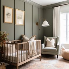 a baby's room with a crib, chair and pictures on the wall