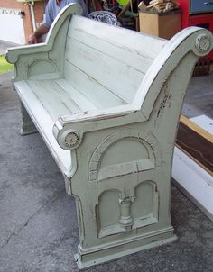 an old wooden bench sitting on the ground