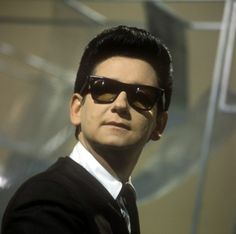 a man wearing sunglasses and a black suit