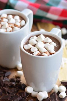 two mugs filled with hot chocolate and marshmallows