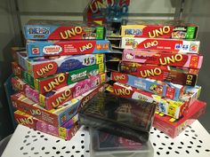 a pile of uno board games sitting on top of a table