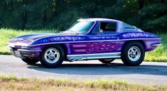 a purple car with flames painted on it