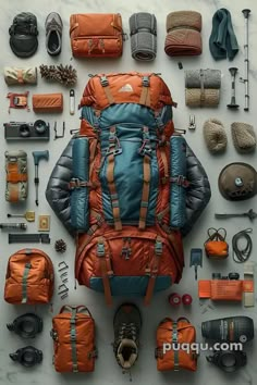 the contents of a backpack laid out on a table with hiking gear and equipment around it