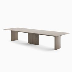 a white table sitting on top of a wooden floor next to a gray wall with no one around it