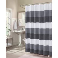 a white and blue shower curtain in a bathroom