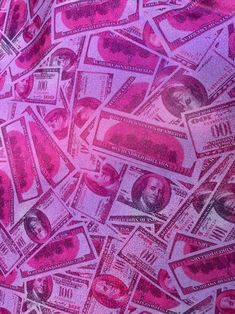 a pile of pink money sitting on top of a table