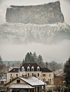 an image of a mountain in the background with snow on it and houses near by