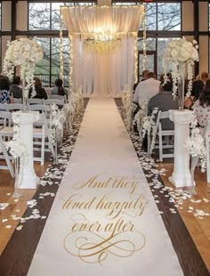 the aisle is decorated with white flowers and petals