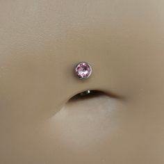 a close up of a ring with a pink stone on it's center piece