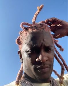 a close up of a person with dreadlocks