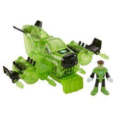 a green and black toy with a man standing next to it