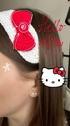 a woman wearing hello kitty earring with red and white bow