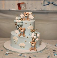 a blue and white cake with teddy bears on it