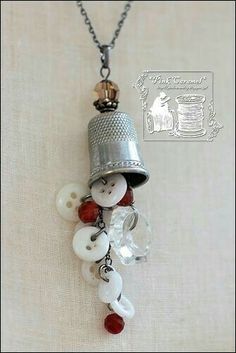 a silver bell with buttons attached to it