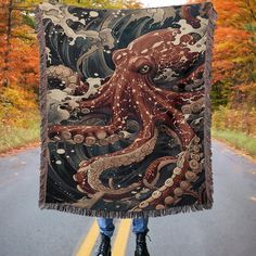 an octopus is on the road holding up a blanket