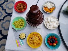 a table topped with bowls filled with different types of food and desserts next to each other