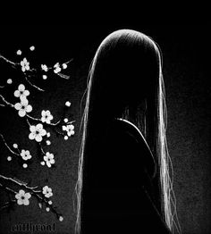 a black and white photo of a woman's face with long hair in front of flowers