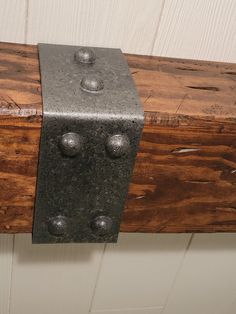 a wooden bench with metal rivets on it