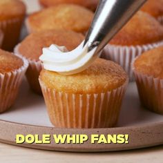 a cupcake being frosted with icing on a plate that says dole whip fans