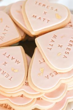 some cookies are arranged in the shape of hearts with words on them that spell out names