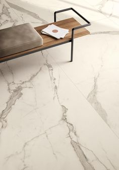 a white marble floor with a wooden table