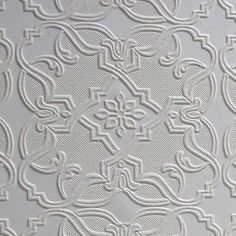 a close up view of an intricate design on a white wallpapered surface,