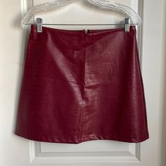 Beautiful Faux Leather Mini Skirt With Back Zipper. New With Tags. Burgundy In Color. Size: 8 Waist: 15in Length: 16.5in Runs Small Due To Being Bought In Europe. More Like A Size 6. European Sizes Differ From Us Sizes. They Run Smaller. Burgundy Mini Skirt, Red Mini Skirt Outfit, Dark Red Skirt, Red Leather Skirt, Red Plaid Skirt, Plaid Wool Skirt, Marvel Clothes, Burgundy Skirt, Belted Mini Skirt