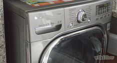 a silver washer sitting next to a dryer