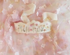 an image of a tiara with flowers and bows on it's headband