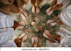 several people standing in a circle with their hands together