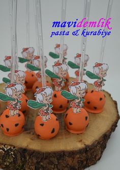 there are many little oranges with toothpicks in the shape of ladybugs