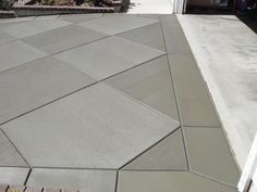 an empty concrete patio in front of a house