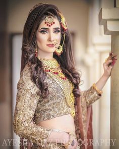 a woman in a bridal outfit posing for the camera