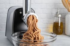 a close up of a food processor being used to make doughnuts in a bowl