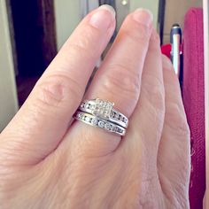 a woman's hand with two wedding rings on it