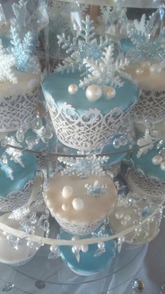 there are many cupcakes that have been decorated with white and blue frosting