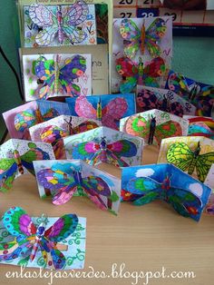 many colorful butterfly cards are displayed on a table