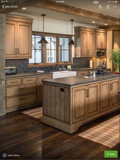 a large kitchen with wooden cabinets and an island