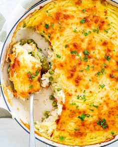 a close up of a casserole in a pan with a spoon